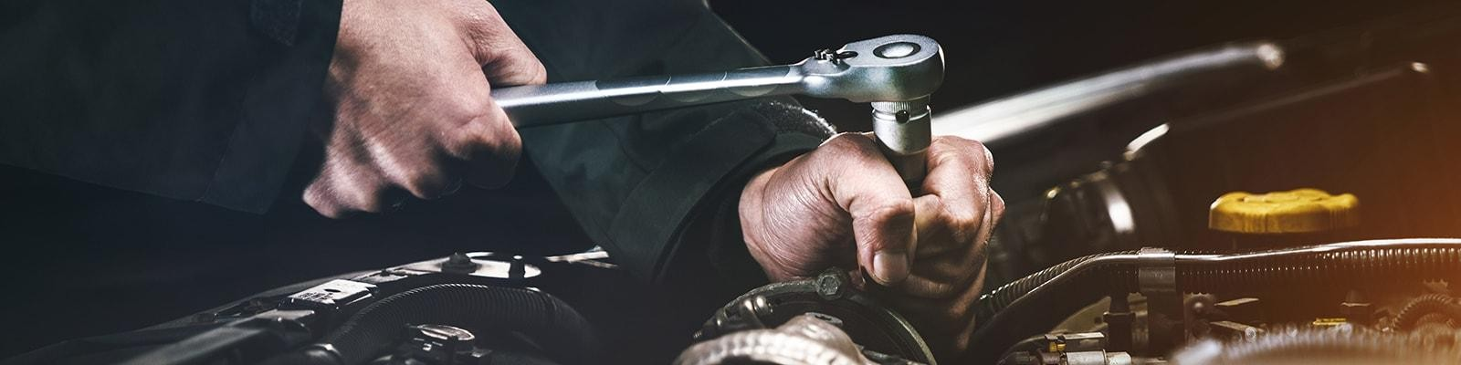 Technician’s hands working on an engine